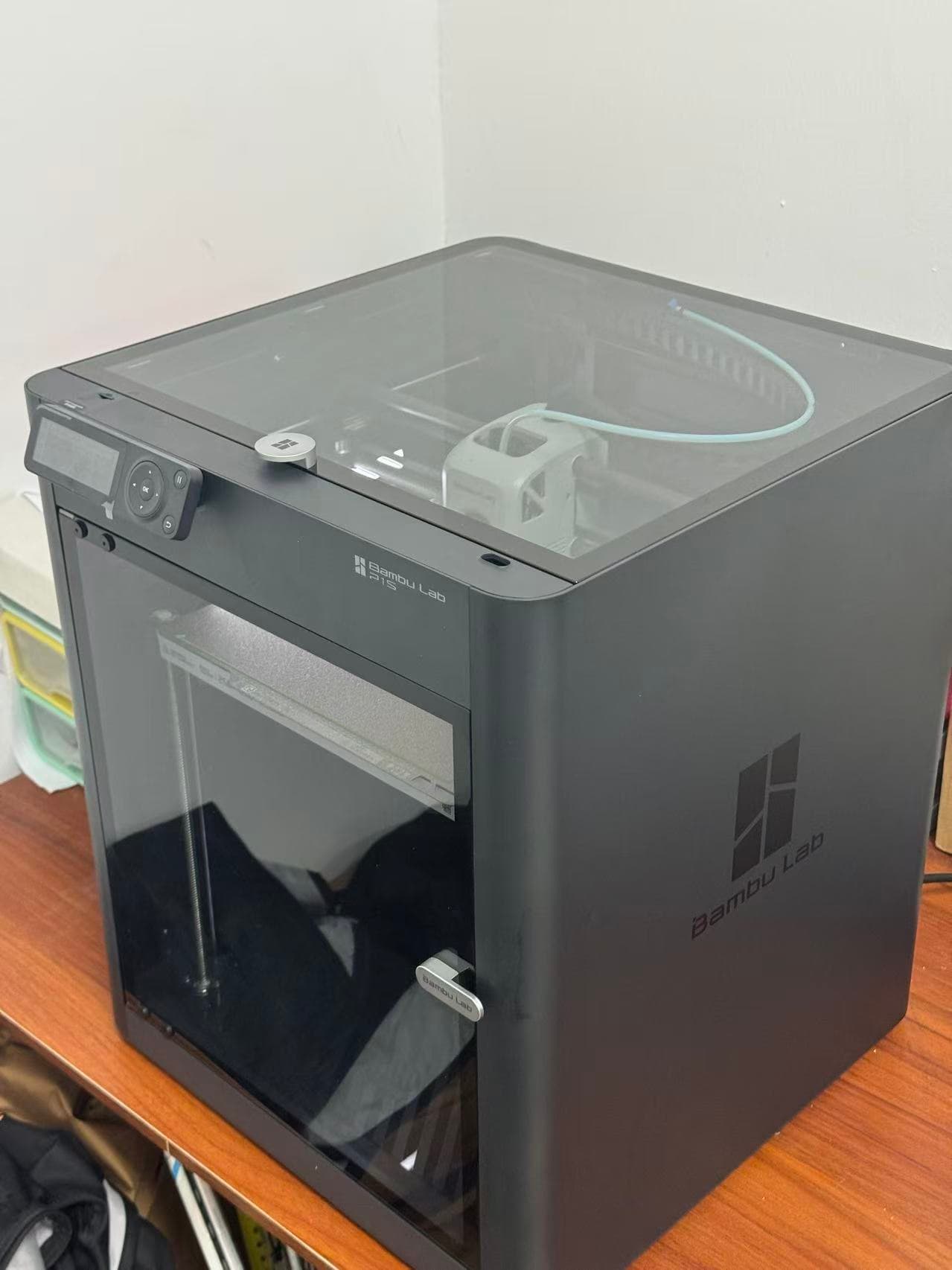 Enclosed Bambu Lab 3D printer set up on a workbench